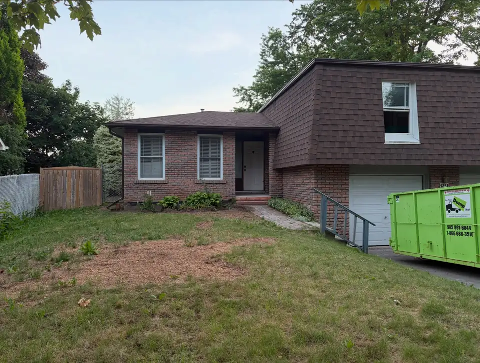 The property before Blacksmoke started, with worn lawn and a plain concrete entry